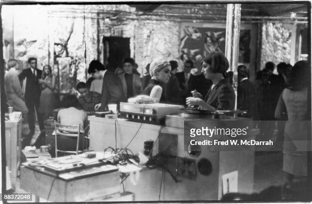 American fashion model and actress Edie Sedgwick stands with an unidentified woman near the dj 'booth' during a party in pop artist Andy Warhol's...