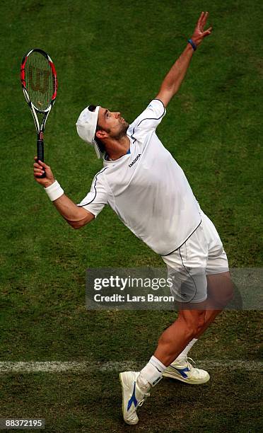 Nicolas Kiefer of Germany serves during his first round match against Viktor Troicki of Serbia on day 2 of the Gerry Weber Open at the Gerry Weber...