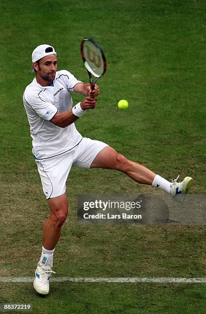 Nicolas Kiefer of Germany plays a backhand during his first round match against Viktor Troicki of Serbia on day 2 of the Gerry Weber Open at the...