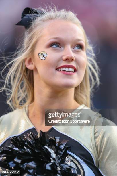 Missouri cheerleader watches the replay board during the game between the Missouri Tigers and the Arkansas Razorbacks on November 24th, 2017 at...