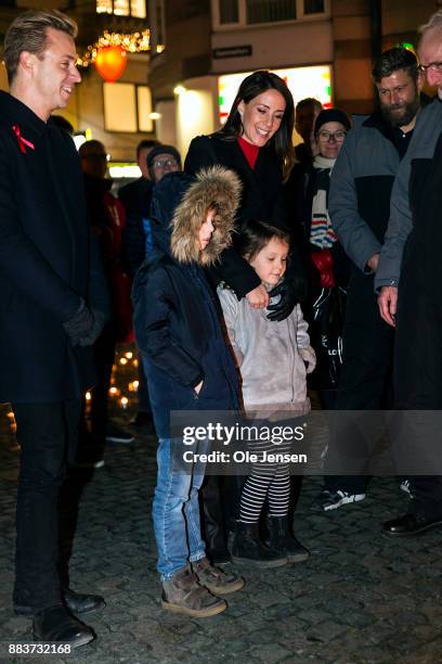 Princess Marie of Denmark and her children Princess Athena and Prince Henrik lights a candle in remembrance of World AIDS Day at Gammel Torv on...