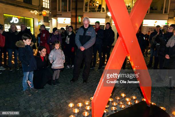 Princess Marie of Denmark and her children Princess Athena and Prince Henrik lights a candle in remembrance of World AIDS Day at Gammel Torv on...