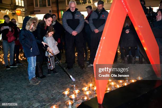 Princess Marie of Denmark and her children Princess Athena and Prince Henrik lights a candle in remembrance of World AIDS Day at Gammel Torv on...