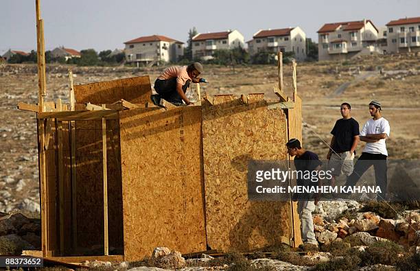 Jewish settlers rebuild a structure at an outpost destroyed by Israeli security forces near the Kokhav Ha Shahar settlement in the occupied West Bank...