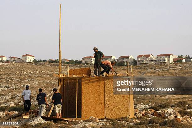 Jewish settlers rebuild a structure at an outpost destroyed by Israeli security forces near the Kokhav Ha Shahar settlement in the occupied West Bank...