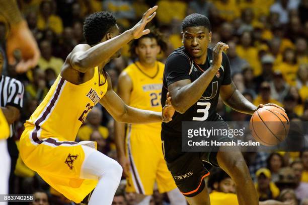 Anthony Lawrence II of the Miami Hurricanes drives to the basket against Davonte Fitzgerald of the Minnesota Golden Gophers during the game on...