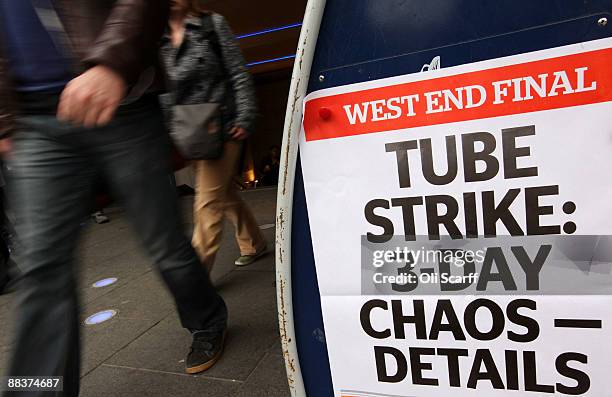 Commuters walk past a newspaper poster announcing the RMT strike outside an Underground station on June 9, 2009 in London, England. A 48 hour strike...