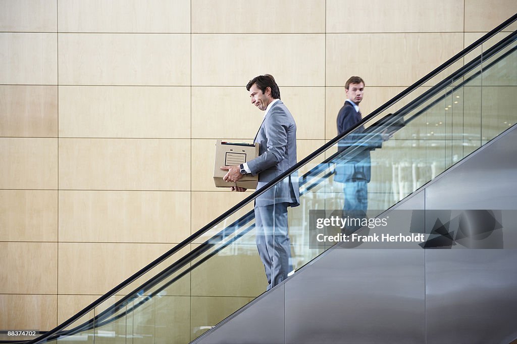 Business men on escalator