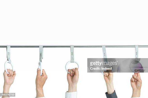 hands holding strap on bar - つり革 ストックフォトと画像