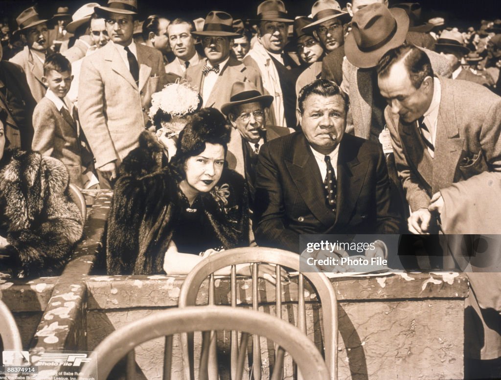 American baseball player George Herman 'Babe' Ruth sits next to his ...