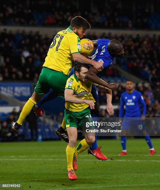 Norwich defender Grant Hanley and Wes Hoolahan challenges Sol Bamba of Cardiff during the Sky Bet Championship match between Cardiff City and Norwich...