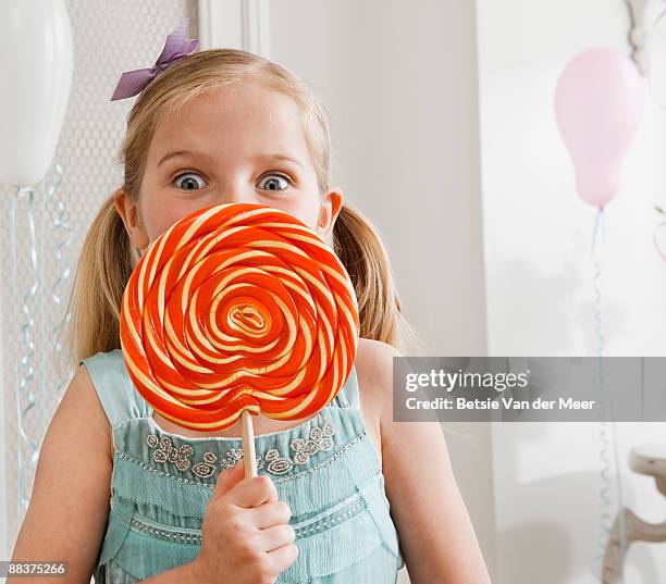 girl holding large lollipop. - large stock pictures, royalty-free photos & images