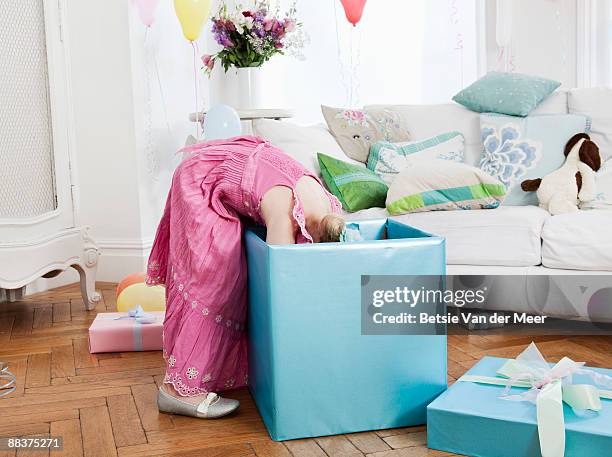 young girl looking into large present - birthday present stock pictures, royalty-free photos & images