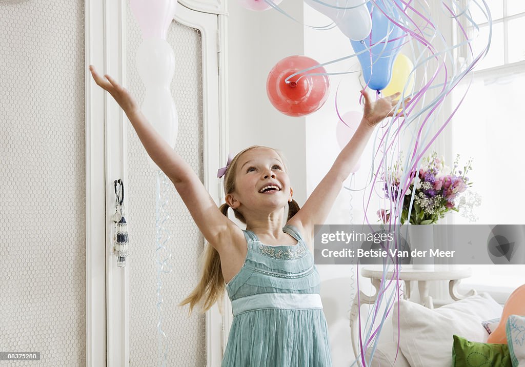 Girl releasing balloons.