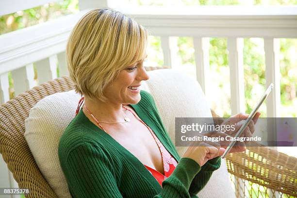 young woman reading from kindle - footage technique stock pictures, royalty-free photos & images