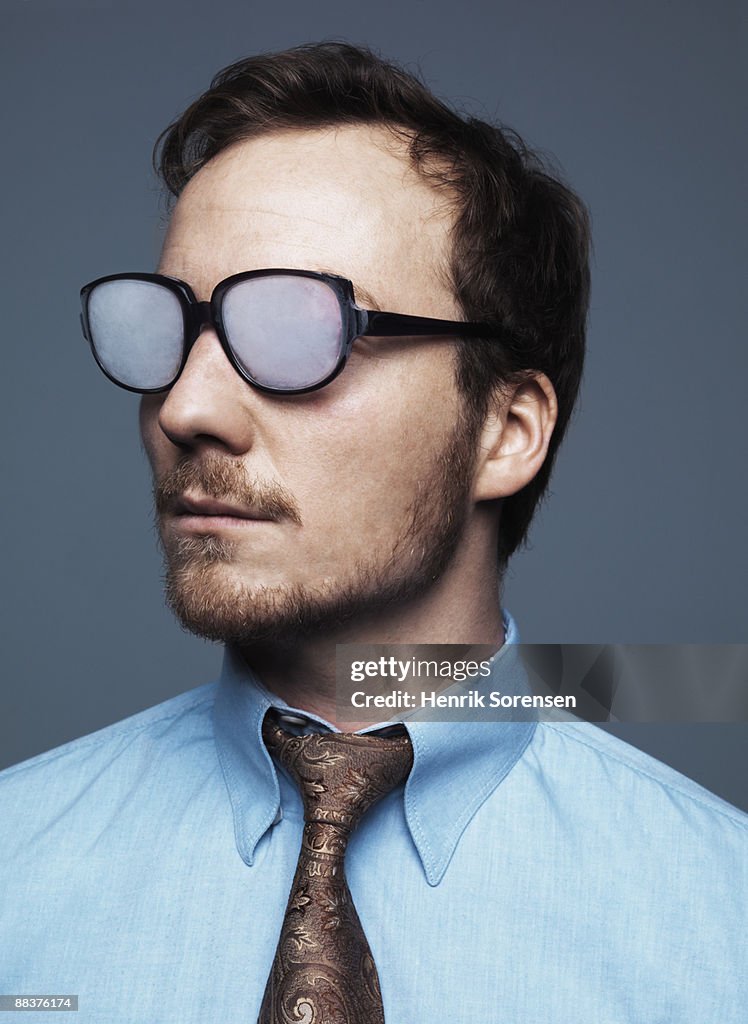 Businessman blinded by foggy glasses