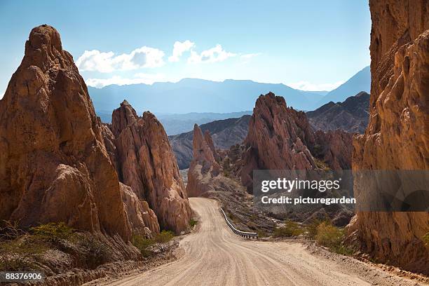 gravel road thru bizarre rock area - argentina dirt road panorama stock pictures, royalty-free photos & images