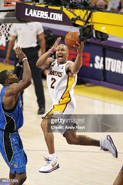 Derek Fisher of the Los Angeles Lakers drives to the basket for a layup against Dwight Howard of the Orlando Magic in Game Two of the 2009 NBA Finals...