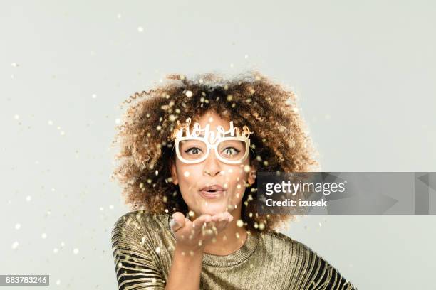 glittering christmas portrait of beautiful young woman in gold sparkles - faces smile celebrate stock pictures, royalty-free photos & images