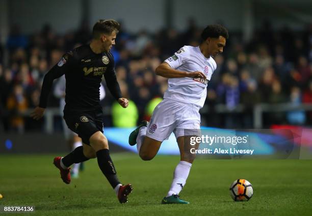 Lewis Montrose of AFC Fylde turns from Lee Evans of Wigan Athletic during The Emirates FA Cup Second Round between AFC Fylde and Wigan Athletic on...