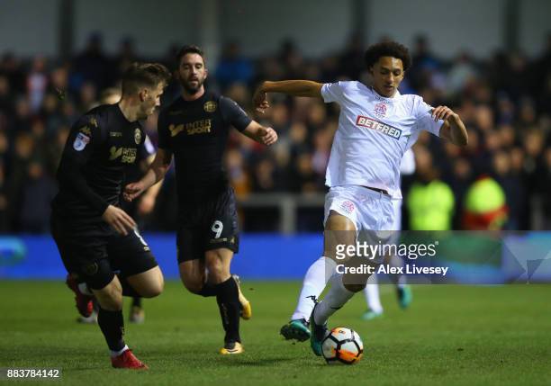 Lewis Montrose of AFC Fylde turns from Lee Evans of Wigan Athletic during The Emirates FA Cup Second Round between AFC Fylde and Wigan Athletic on...