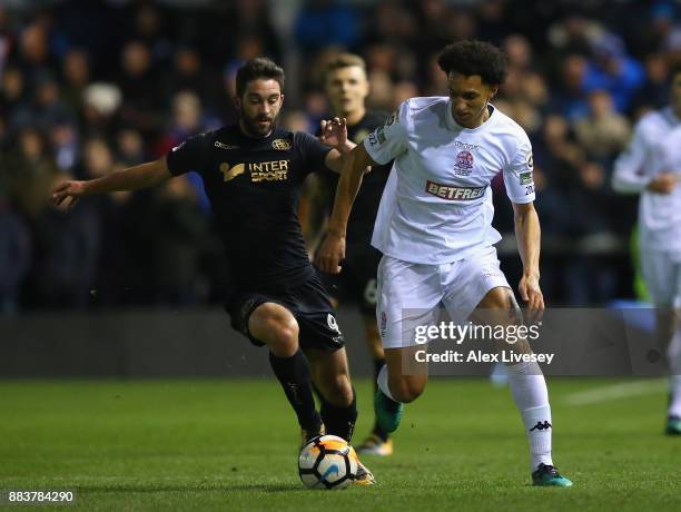 Lewis Montrose of AFC Fylde beats Will Grigg of Wigan Athletic during The Emirates FA Cup Second Round between AFC Fylde and Wigan Athletic on...