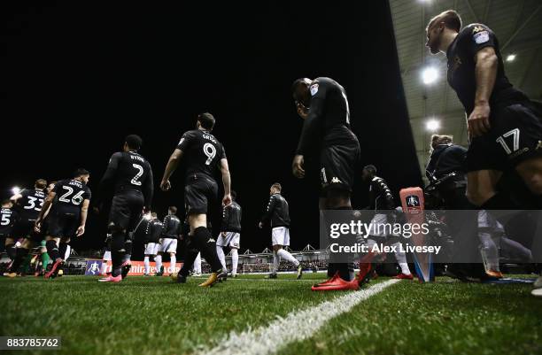 The players of Wigan Athletic walk out for The Emirates FA Cup Second Round between AFC Fylde and Wigan Athletic on December 1, 2017 in Kirkham,...