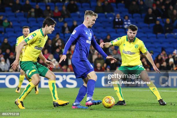 Danny Ward of Cardiff City is marked by Timm Klose of Norwich City and Grant Hanley during the Sky Bet Championship match between Cardiff City and...