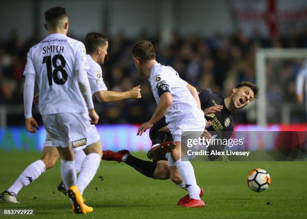 Lee Evans of Wigan Athletic is fouled by Sam Finley of AFC Fylde during The Emirates FA Cup Second Round between AFC Fylde and Wigan Athletic on...