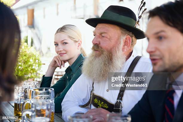 germany, bavaria, upper bavaria, people in beer garden - bavaria traditional stock pictures, royalty-free photos & images