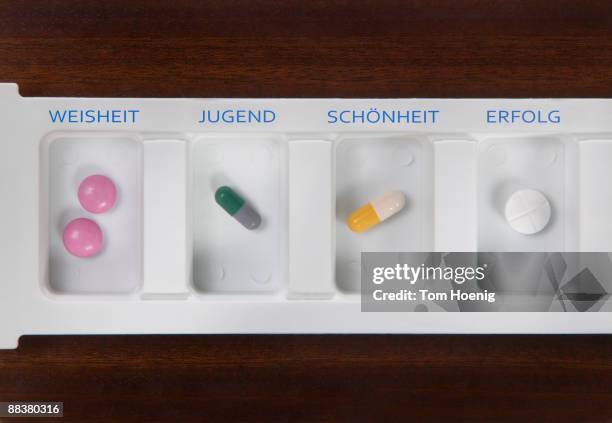 pills inside pill box, elevated view - tablettenbox deutsch stock-fotos und bilder