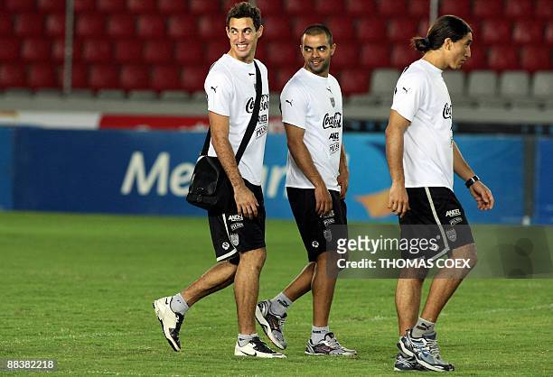 Uruguayan footballers Martin Silva, Diego de Souza and Juan Castillo leave the field on the eve of their FIFA World Cup South Africa-2010 qualifier...