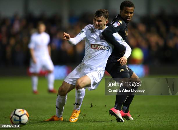 Jonny Smith of AFC Fylde holds off a challege from Nathan Byrne of Wigan Athletic during The Emirates FA Cup Second Round between AFC Fylde and Wigan...
