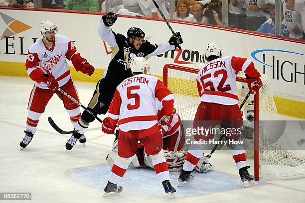 Tyler Kennedy of the Pittsburgh Penguins celebrates after scoring a goal in the third period against Darren Helm, Nicklas Lidstrom, Jonathan Ericsson...