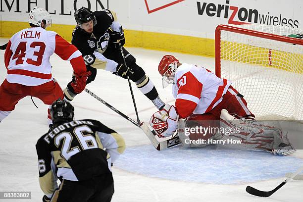 Tyler Kennedy of the Pittsburgh Penguins shoots a goal past goaltender Chris Osgood of the Detroit Red Wings during Game Six of the NHL Stanley Cup...