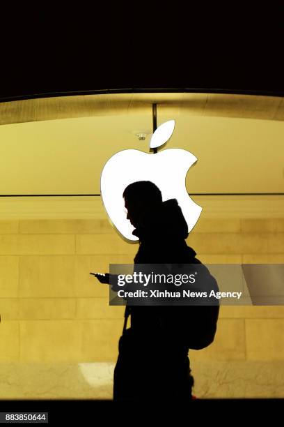 Dec. 1, 2017 -- A man checks his phone at the Apple store inside the Grand Central Terminal in New York, the United States, Nov. 30, 2017. U.S....