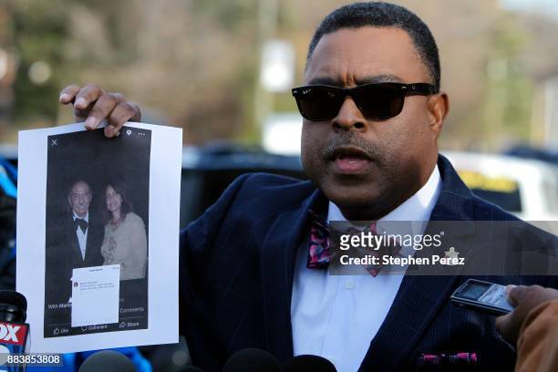 Attorney Arnold Reed displays a photo of Rep. John Conyers and Marion Brown outside Conyers home on December 1, 2017 in Detroit, Michigan. Reed is...