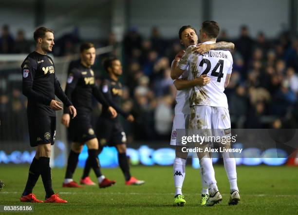 Simon Grand and George Edmundson of AFC Fylde celebrate after The Emirates FA Cup Second Round between AFC Fylde and Wigan Athletic on December 1,...