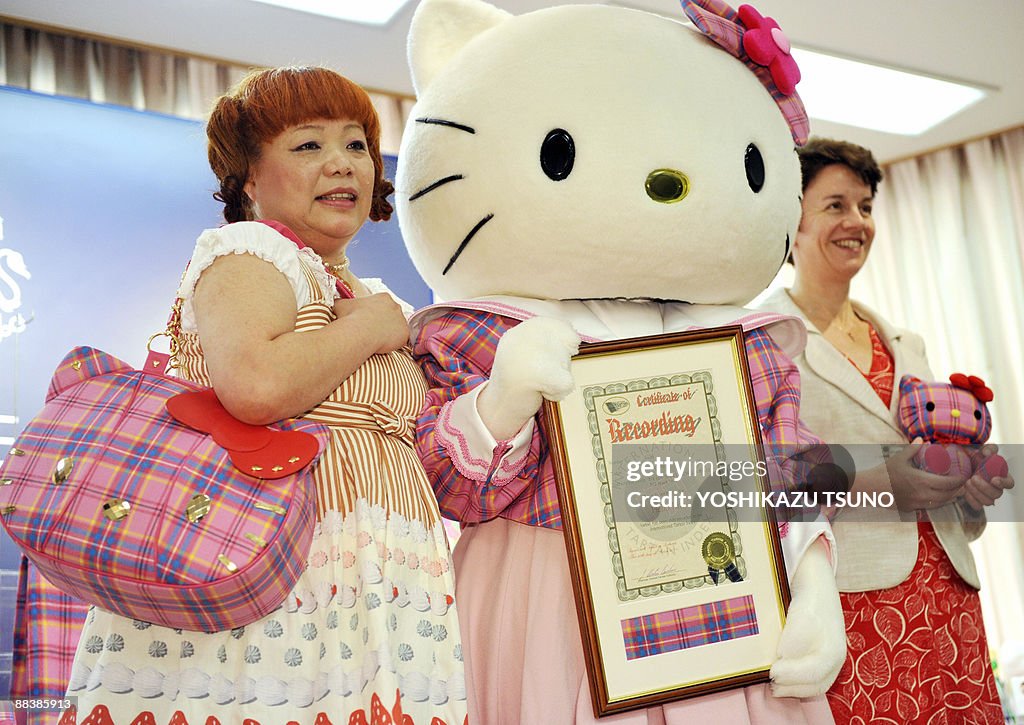 A Hello Kitty character wears a tartan c