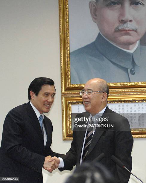 Taiwan's President Ma Ying-jeou and Wu Po-hsiung, outgoing chairman of the ruling Kuomintang party, shake hands during a press conference in Taipei...