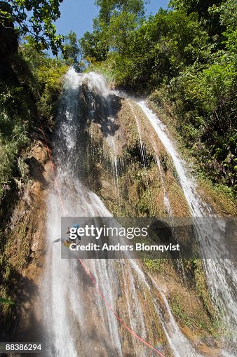 Woman Ralphing Woman Rappelling Down A Waterfall In Nepal High-Res Stock Photo - Getty ...