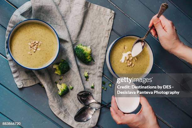 delicious vegetable cream soup - plate in hand stockfoto's en -beelden