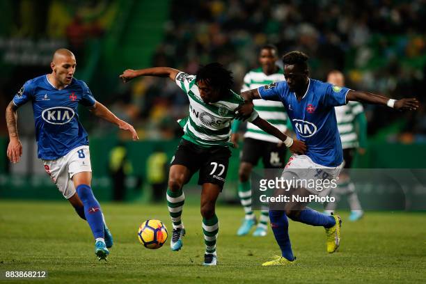 Sporting's forward Gelson Martins vies for the ball with Belenenses's midfielder Andre Sousa and Belenenses's midfielder Bouba Sare during Primeira...