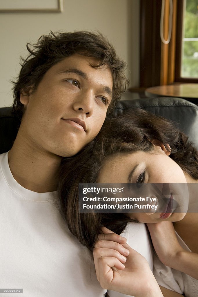 Young man and young woman leaning on eachother