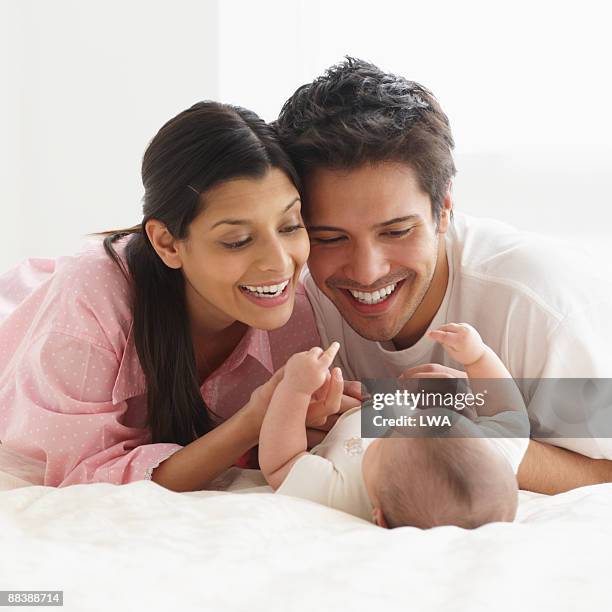 parents admiring infant daughter - filipino mother baby stock pictures, royalty-free photos & images