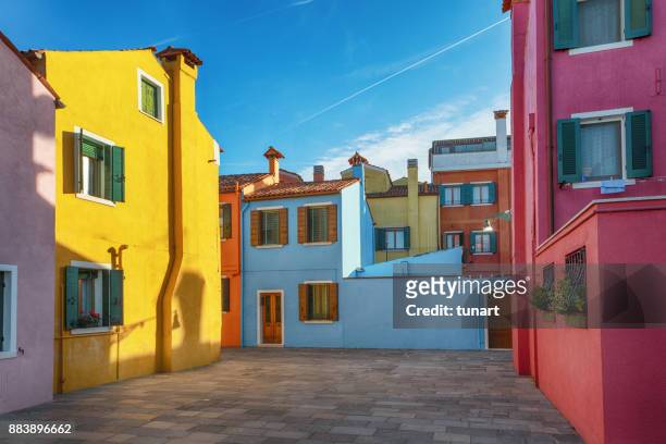 alleys of colorful buildings of burano, venice, italy - colour saturation stock pictures, royalty-free photos & images