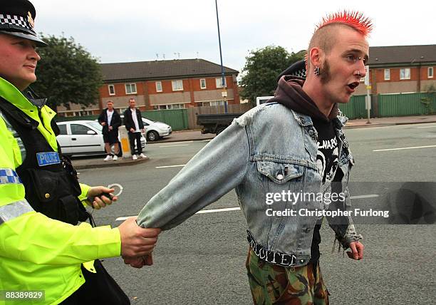 Protester is led away by police as Leader of the British National Party, Nick Griffin MEP gives a media conference in the Ace of Diamonds pub on June...