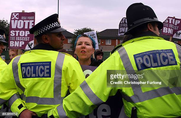 Protestors are held back by police as Leader of the British National Party, Nick Griffin MEP gives a media conference in the Ace of Diamonds pub on...