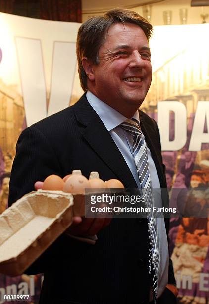 Leader of the British National Party, Nick Griffin MEP poses with a box of eggs as he gives a media conference in the Ace of Diamonds pub on June 10,...