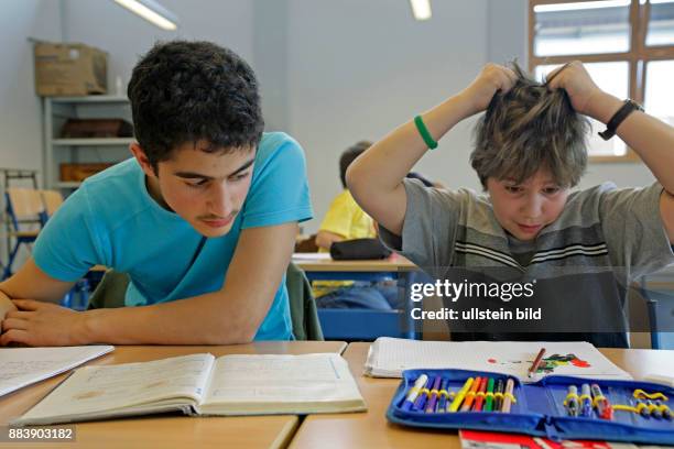 Boy tearing his hair at class